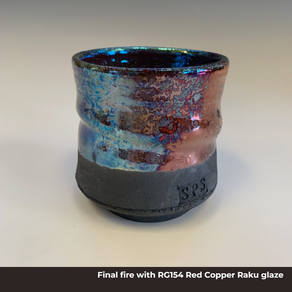 A cup made from raku clay, it is black on the bottom and glazed with shiny metallic colors on the top