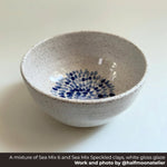 Speckled ceramic bowl with blue floral pattern on a white background, Made with a mixture of Seattle Pottery Supply Sea Mix 6 and Sea Mix Speckled clays