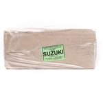 A packaged block of Suzuki porcelain, with the Seattle Pottery Supply brand name visible on the label, wrapped in plastic.